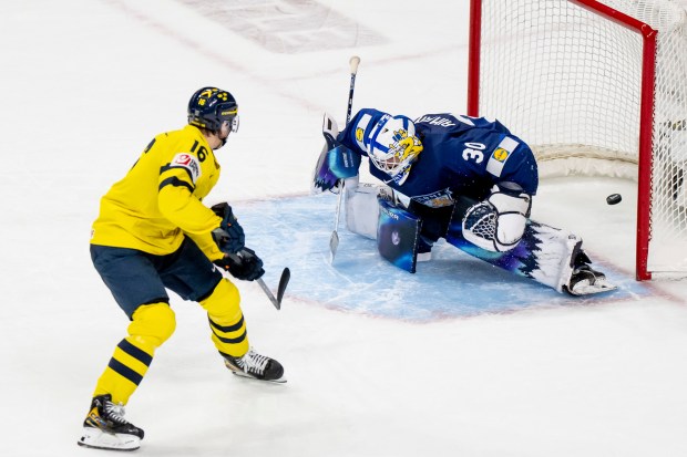 Sweden's Anton Frondell scores the winning goal on Finland goaltender Petteri Rimpinen during the shootout of a semifinal at the IIHF World Junior Hockey Championship on Sunday, Jan. 4, 2026, in St. Paul, Minn. Sweden won 4-3 and went on to win the championship. (Christopher Katsarov/The Canadian Press via AP)