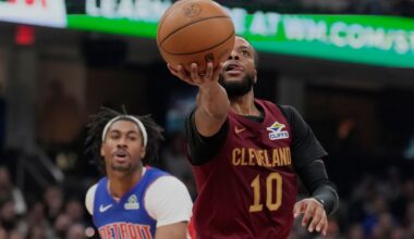 Cleveland Cavaliers guard Darius Garland (10) goes to the basket in front of Detroit Pistons guard Jaden Ivey (23) in the first half of an NBA basketball game Sunday, Jan. 4, 2026, in Cleveland.