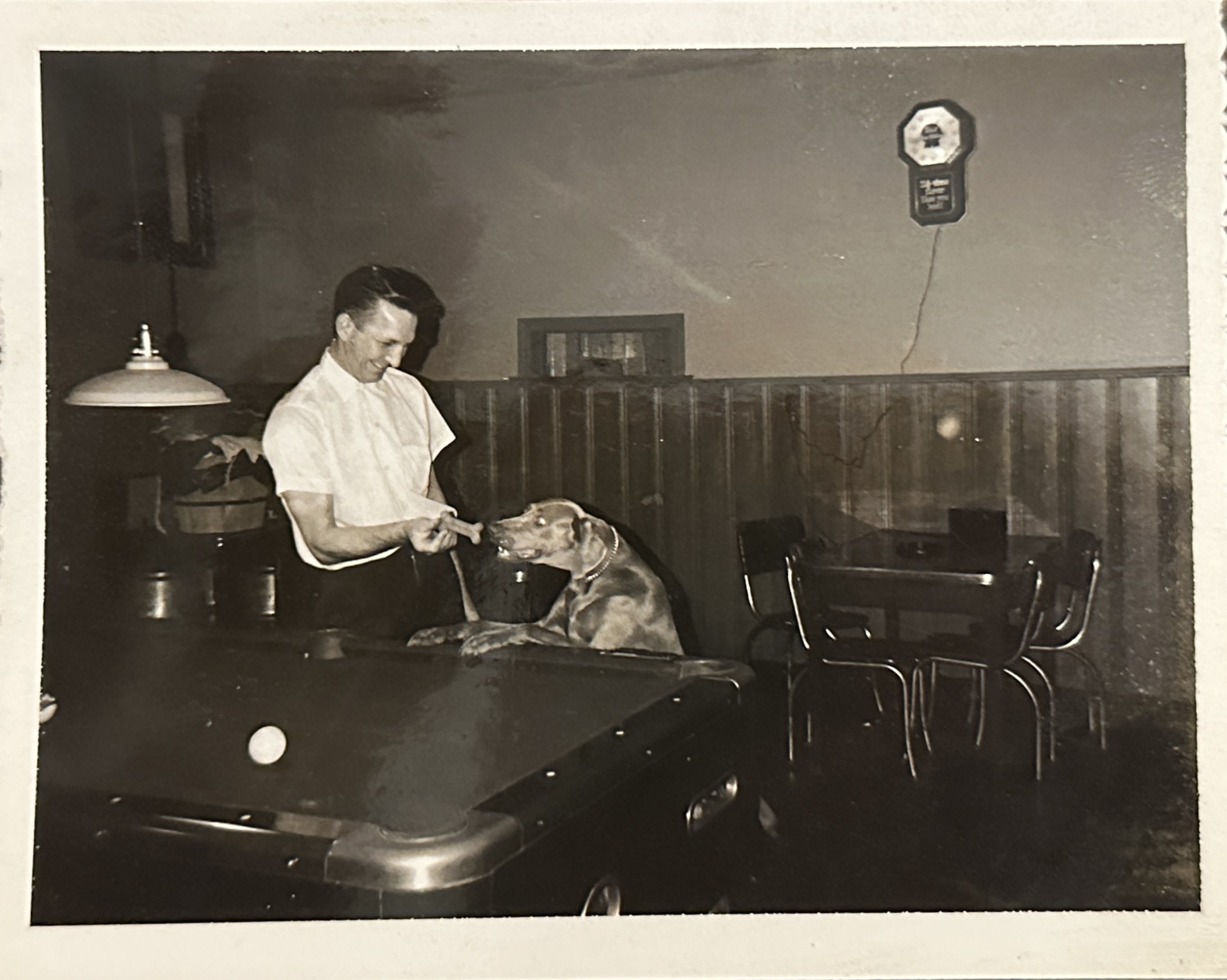A man and a dog in a black and white photo from Belmont Tavern.