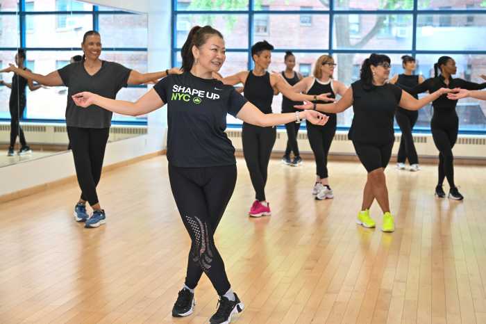 a group of people dressed in black participating in one NYC's free fitness classes 