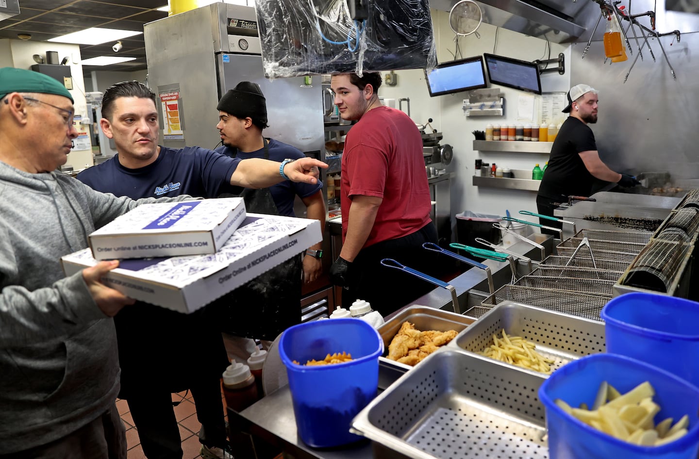Costa Alexandrou, second from left, the owner of the chain Nick's Place, said the decision to switch to artificial receptionists came in 2024 when many of his counter workers had graduated high school and moved away.