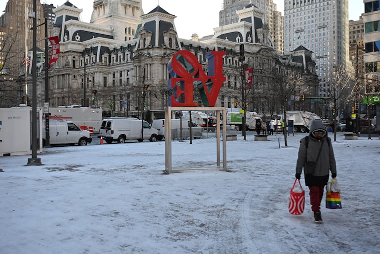 An early morning snow squall left a dusting in LOVE Park before the start of the Mummers Parade on Jan. 1.