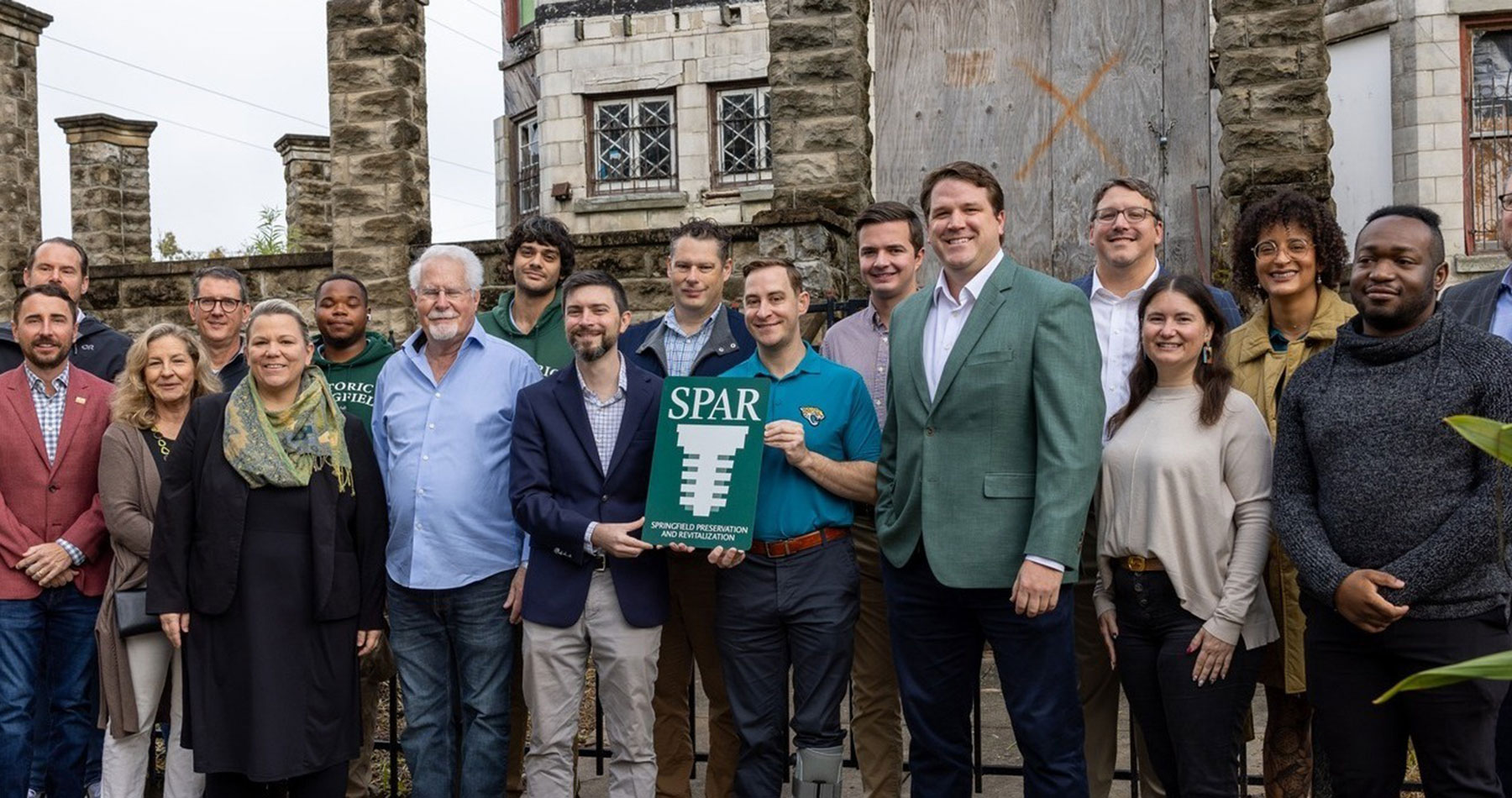 SPAR Executive Director Michael Haskins stands center with District 7 City Councilmember Jimmy Peluso, joined by other city and community stakeholders, at the Dec. 8 press conference announcing SPAR’s acquisition of the Drew Mansion.