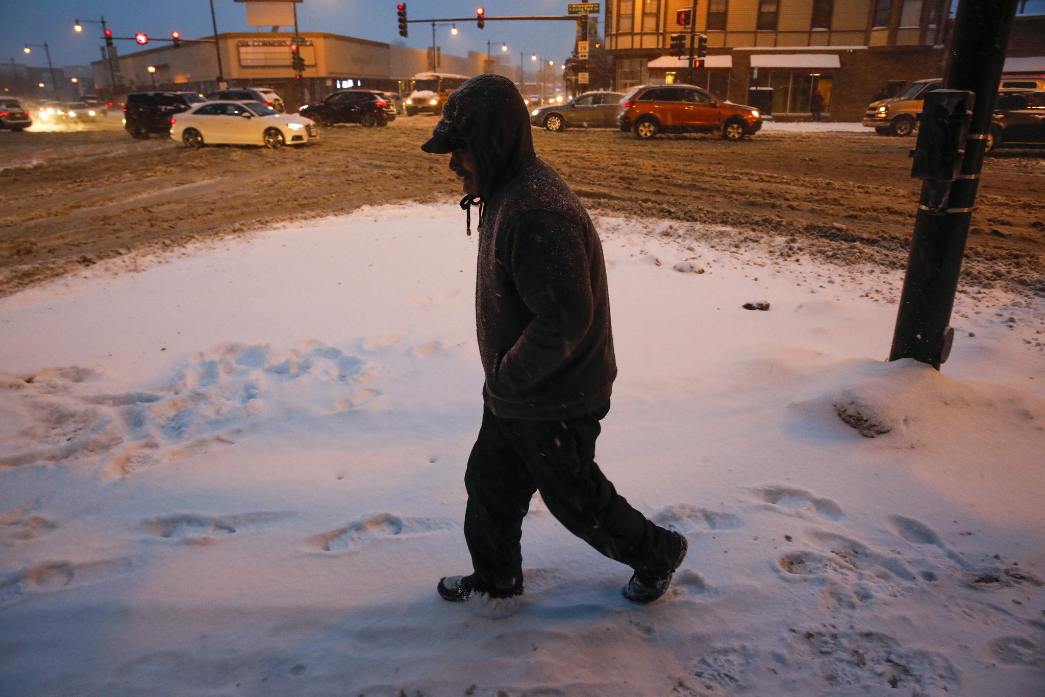 A man walks on West Irving Park Road in the...