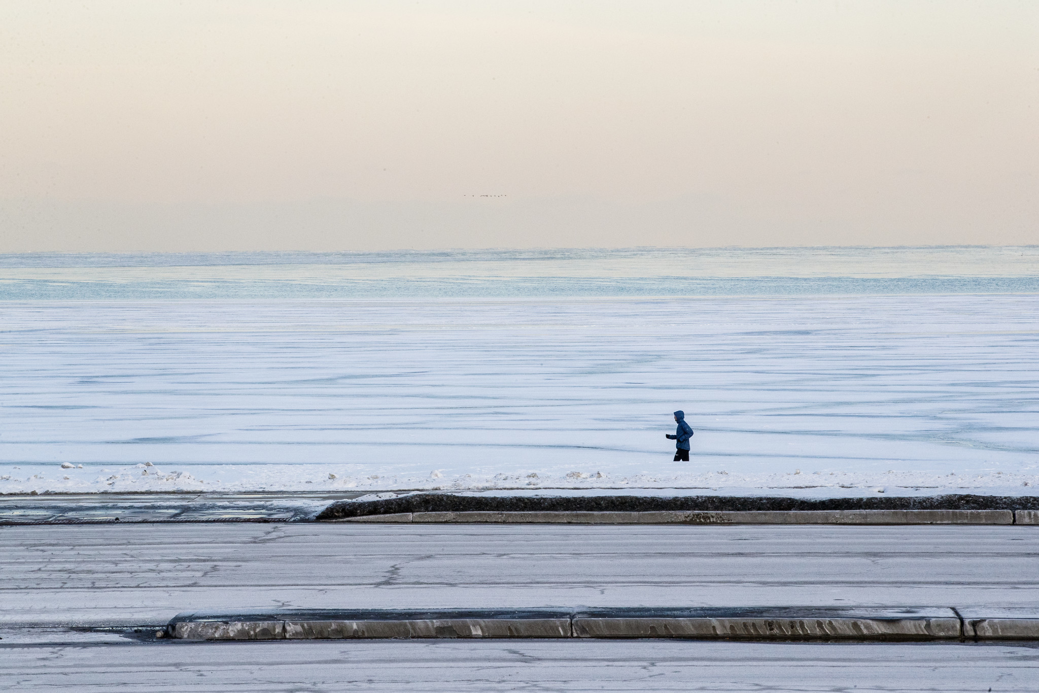 A pedestrian jogs along the lakefront near Monroe Harbor on...