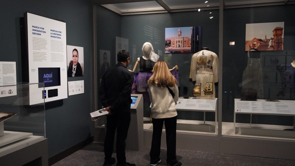 Visitors at the Chicago History Museum's "Aqui en Chicago” exhibit, exploring the history and cultural impact of Chicago's Latino communities.