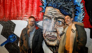 Hidden City supervising producer, Nathaniel Popkin (left) and Julien Suaudeau, at the David Lynch mural outside of Love City Brewing. Their new podcast investigates how David Lynch invented a "cinematic language of fear and strangeness in Philadelphia.”
