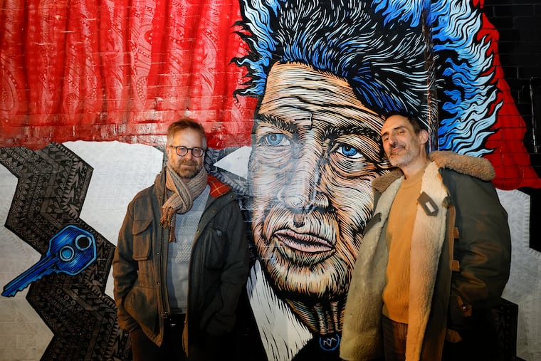 Hidden City supervising producer, Nathaniel Popkin (left) and Julien Suaudeau, at the David Lynch mural outside of Love City Brewing. Their new podcast investigates how David Lynch invented a "cinematic language of fear and strangeness in Philadelphia.”