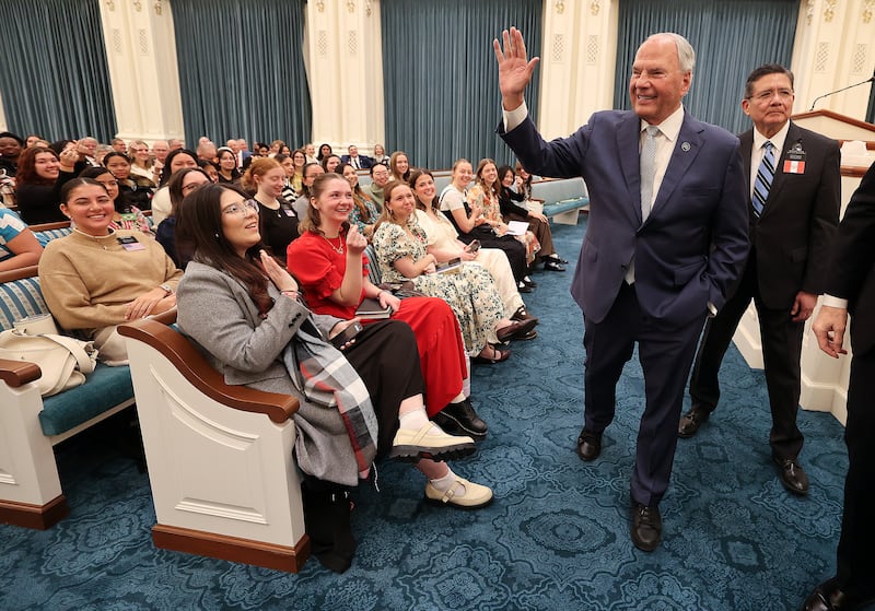 Elder Ronald A. Rasband waves as he leaves a missionary devotional at the Joseph Smith Memorial Building in Salt Lake City on Friday, Jan. 9, 2026.