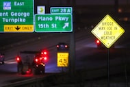 A truck sprays an anti-icing agent on US 75 near Renner Road during a winter storm on...
