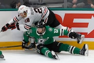 Chicago Blackhawks left wing Andre Burakovsky (28) tangles with Dallas Stars defenseman Esa...