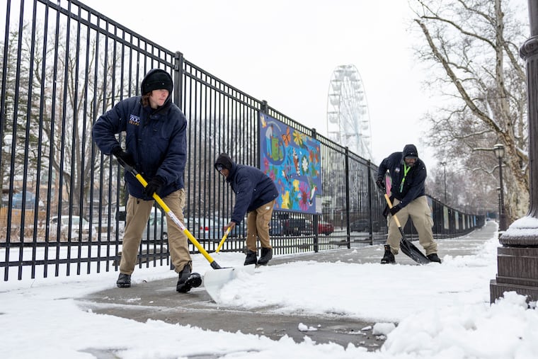 (From left to right) Philadelphia Zoo Garden Service workers Joseph Mineer, of Fairmount; Naeem Price, of North Philadelphia; and David Wallace, of Southwest Philadelphia, are shoveling snow on the sidewalks near the bus drop-offs in Philadelphia, Pa., on Saturday, Jan. 17, 2026.