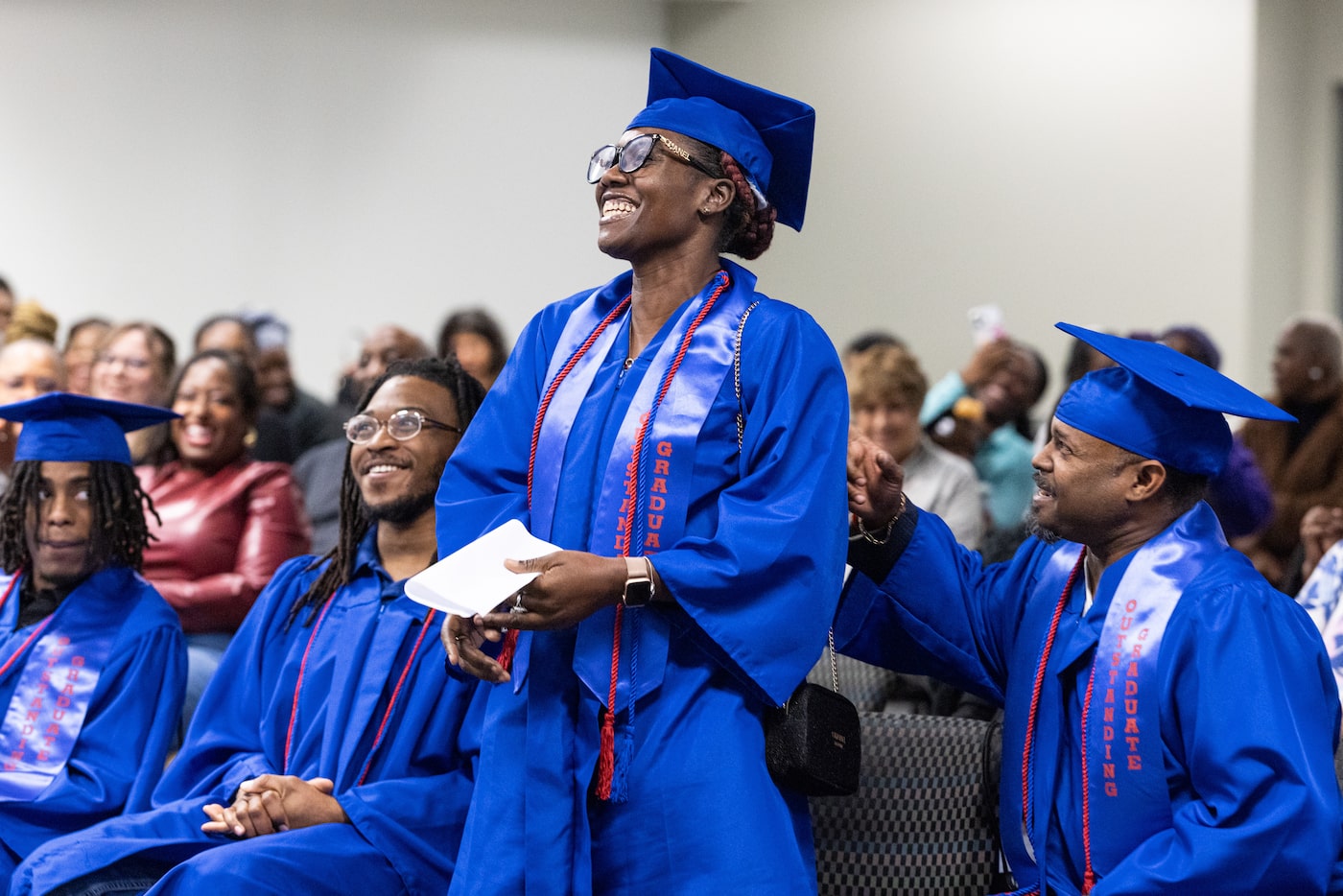 Dallas College construction and HVAC student David LaFlore pats Brendetta McDonald on the...