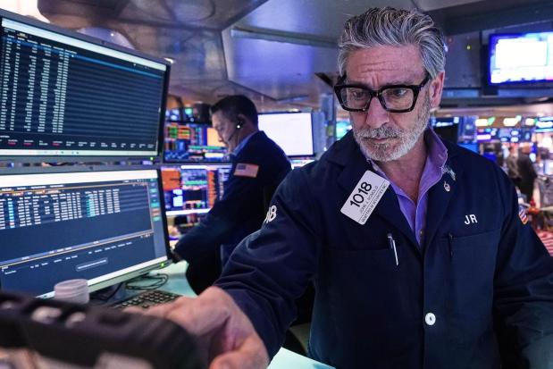 Trader John Romolo works on the floor of the New York Stock Exchange in December. (AP Photo/Richard Drew)