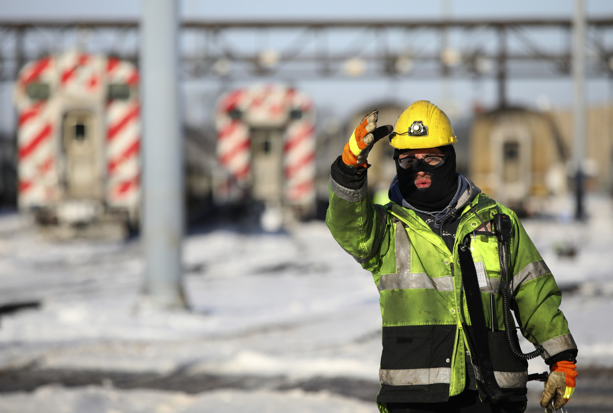 Metra carman Diego Lopez helps bring a train car into...