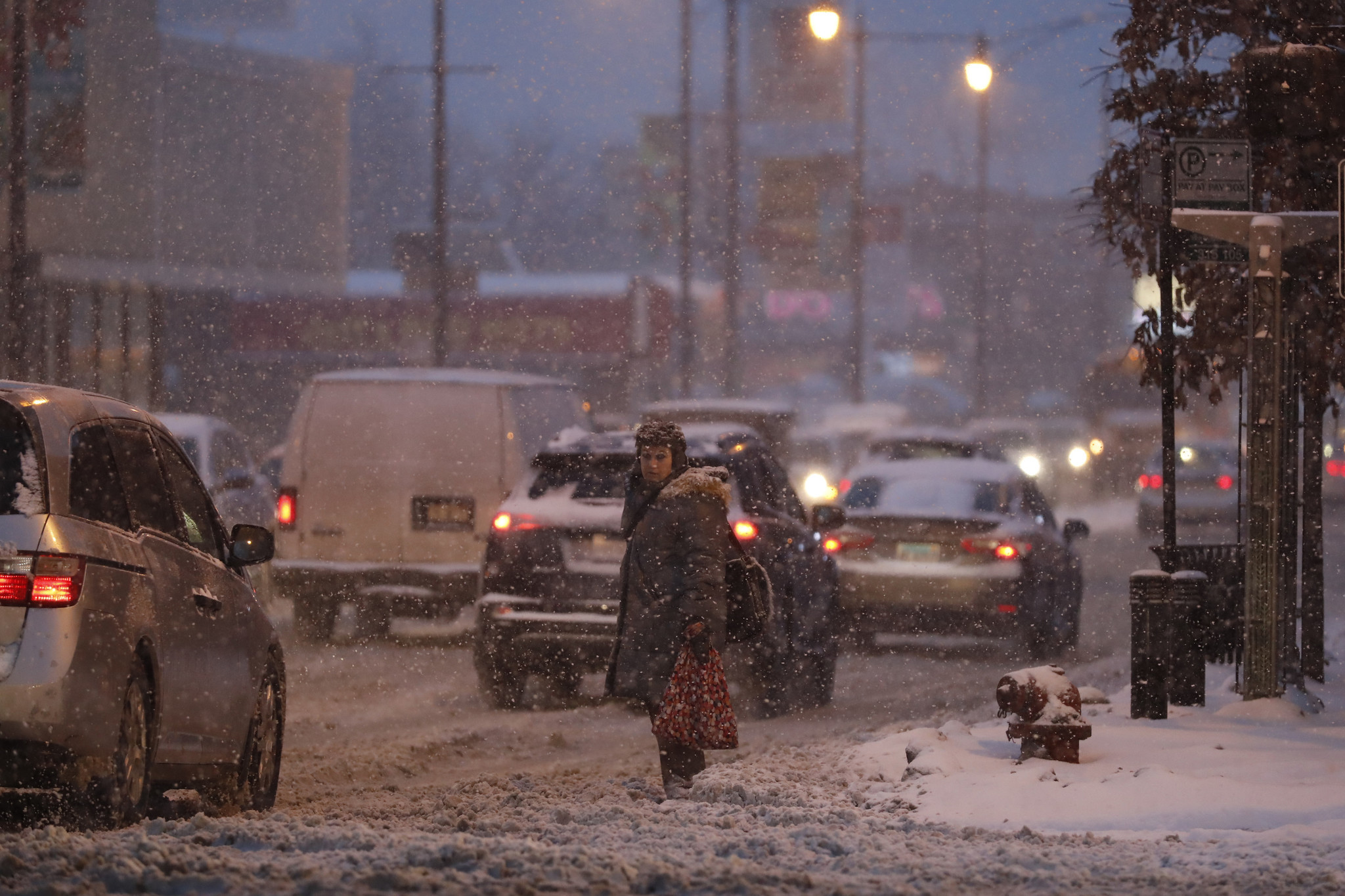 A pedestrian waits to cross North Cicero Avenue in the...