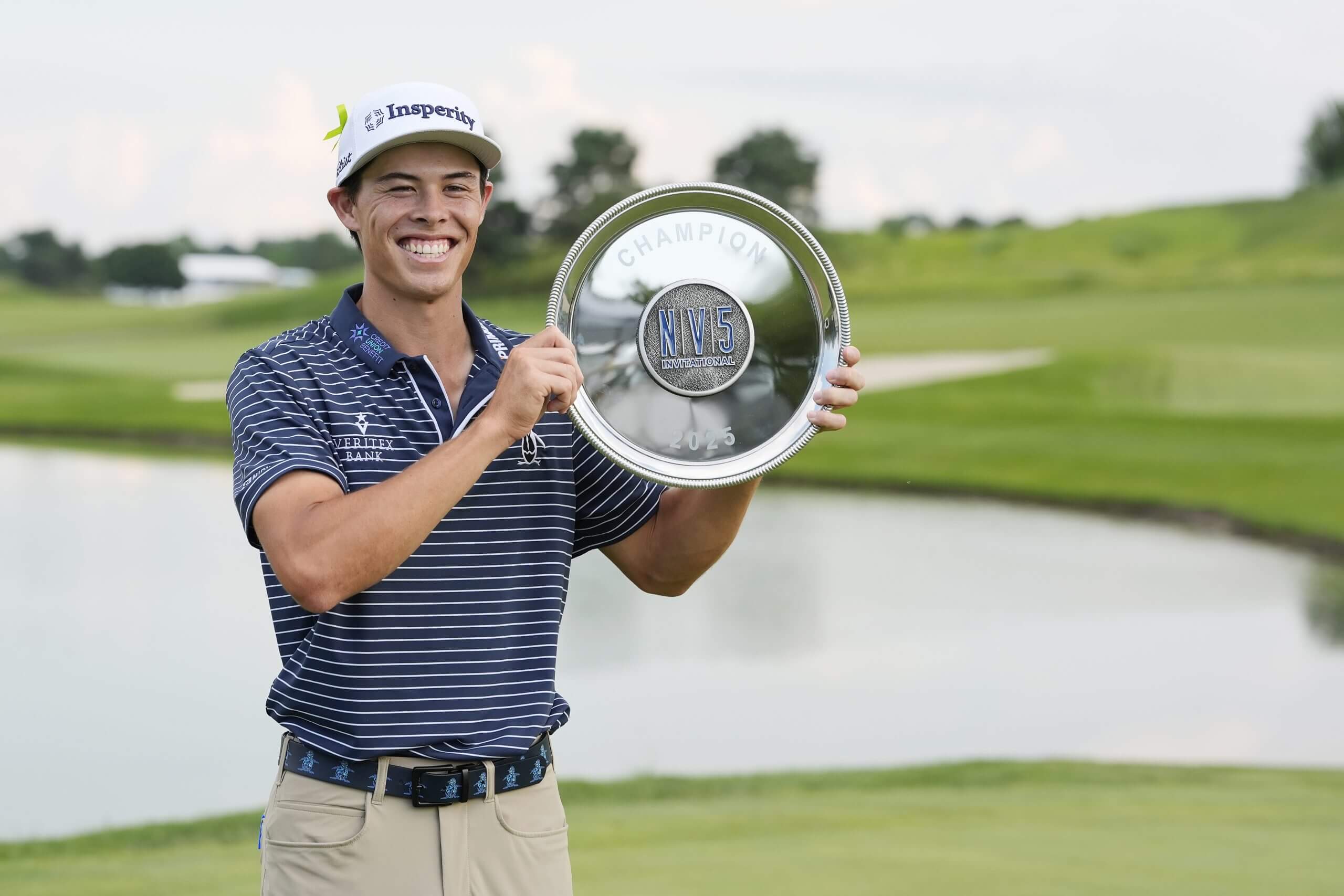 Johnny Keefer holds a trophy.