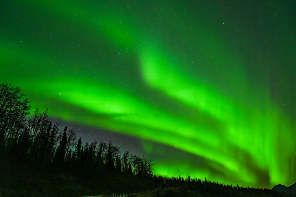 ALASKA, UNITED STATES - SEPTEMBER 30: Intense northern lights (aurora borealis) above Kp5 were observed in Alaska's Matanuska-Susitna Borough, around Chickaloon and Bonnie Lake, on the night of September 30 to October 01, 2025. The aurora created a breathtaking scene, illuminating the snow-capped peaks of the mountains surrounding the Matanuska Valley and their reflections on Bonnie Lake. (Photo by Hasan Akbas/Anadolu via Getty Images)