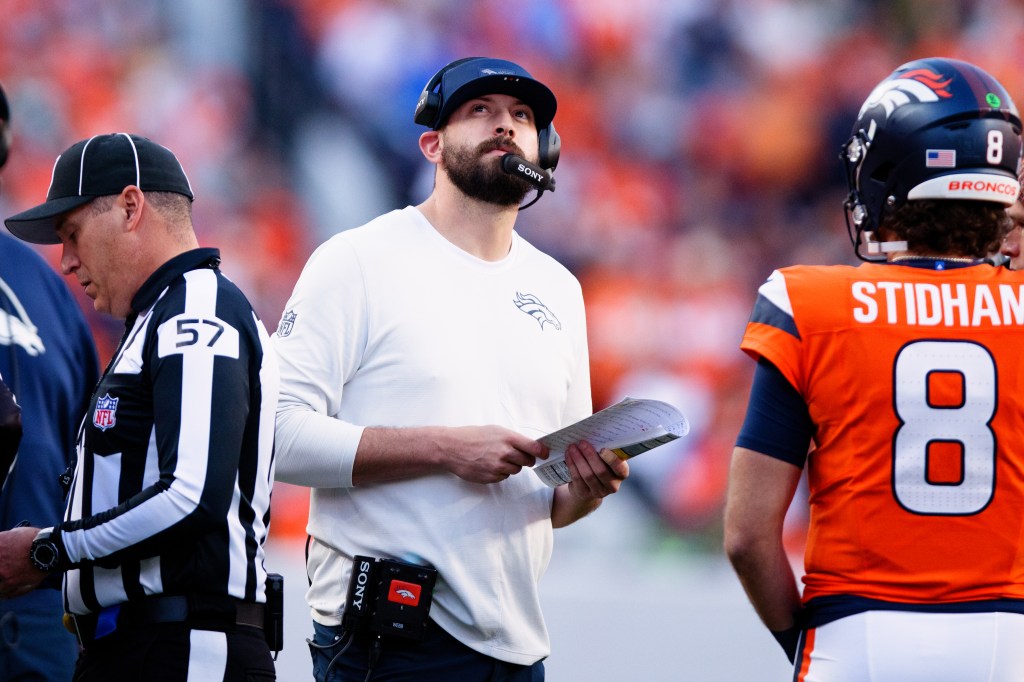 Offensive Pass Game Coordinator and Quarterbacks Coach Davis Webb of the Denver Broncos looks on during the second quarter against the Green Bay Packers at Empower Field at Mile High on December 14, 2025 in Denver, Colorado.
