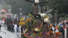 The America250 float "Soaring Onward Together for 250 Years" with a trio of Bald Eagles moves down the parade route in the rain during the 137th Rose Parade on New Years Day in Pasadena, California, on January 1, 2026. The parade features floral floats, marching bands and equestrian units to ring in the New Year along the 5.5 mile (8.8 km) route along Colorado Blvd in Pasadena. (Photo by Patrick T. Fallon / AFP via Getty Images)