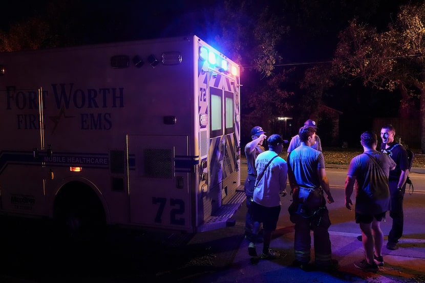 Fort Worth Fire Department Capt. Trent Robinson (far right) talks with fellow firefighters...