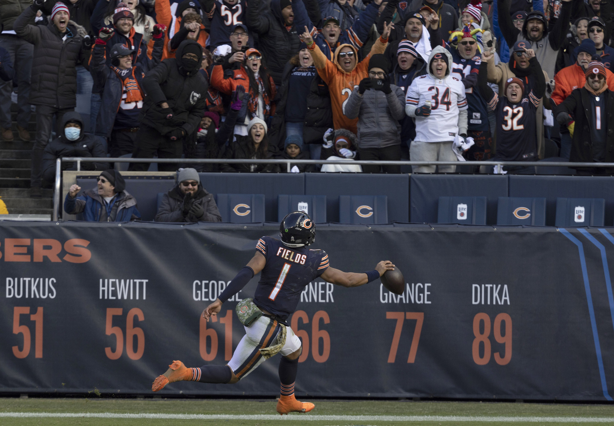 Bears quarterback Justin Fields runs in the end zone for...