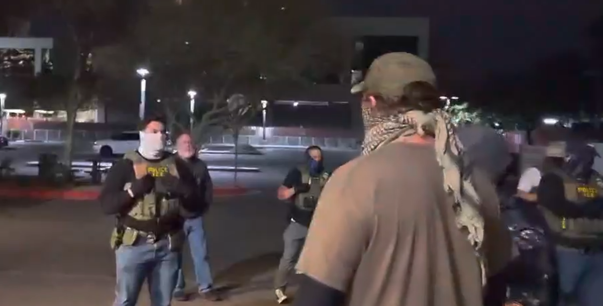 masked ice agents and protesters confront each other