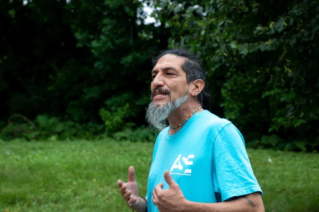 man passionately talks to tour group about environmental impacts in his Chicago Southeast Side community