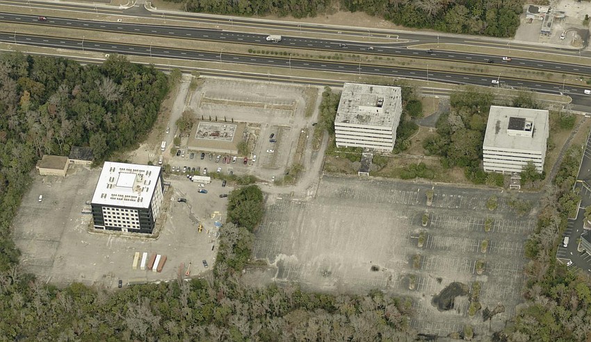 An aerial view of renovated Interra Apartment Homes, left, at 8000 Arlington Expressway.  The two vacant Offshore Power Systems office buildings, at right, are also planned for renovation into apartments.