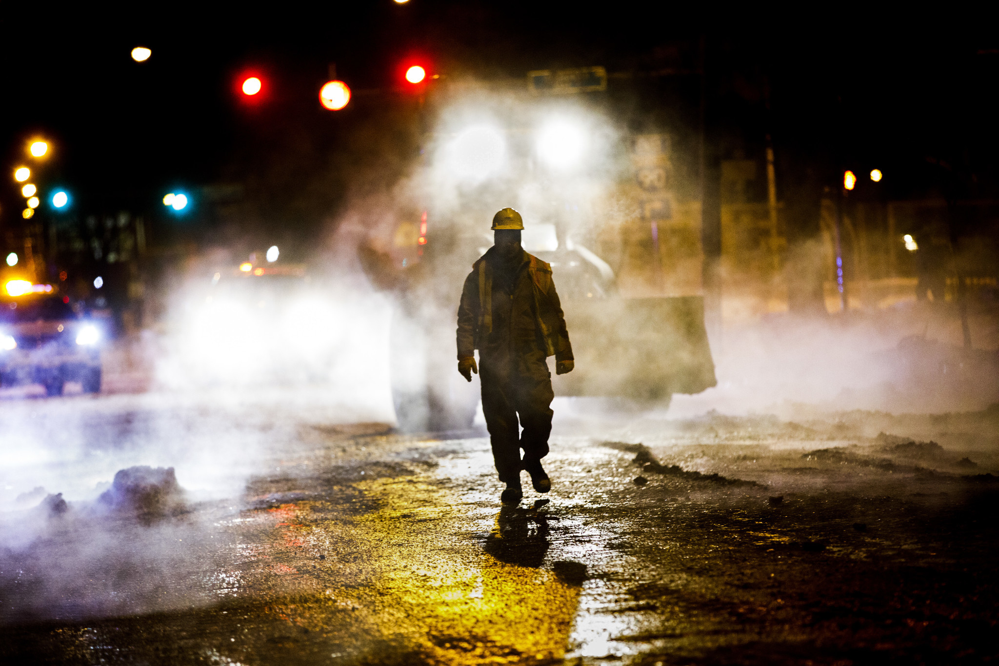 Crews work the scene of a broken water pipe that...