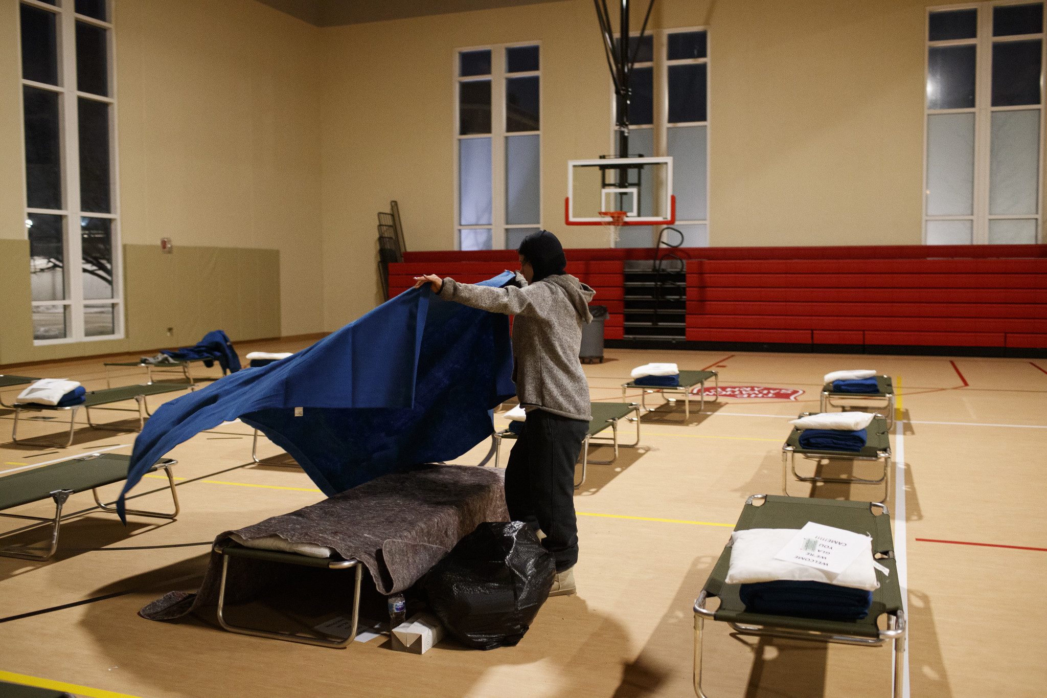 Stephanie Haaser, 32, gets her cot ready before going to...