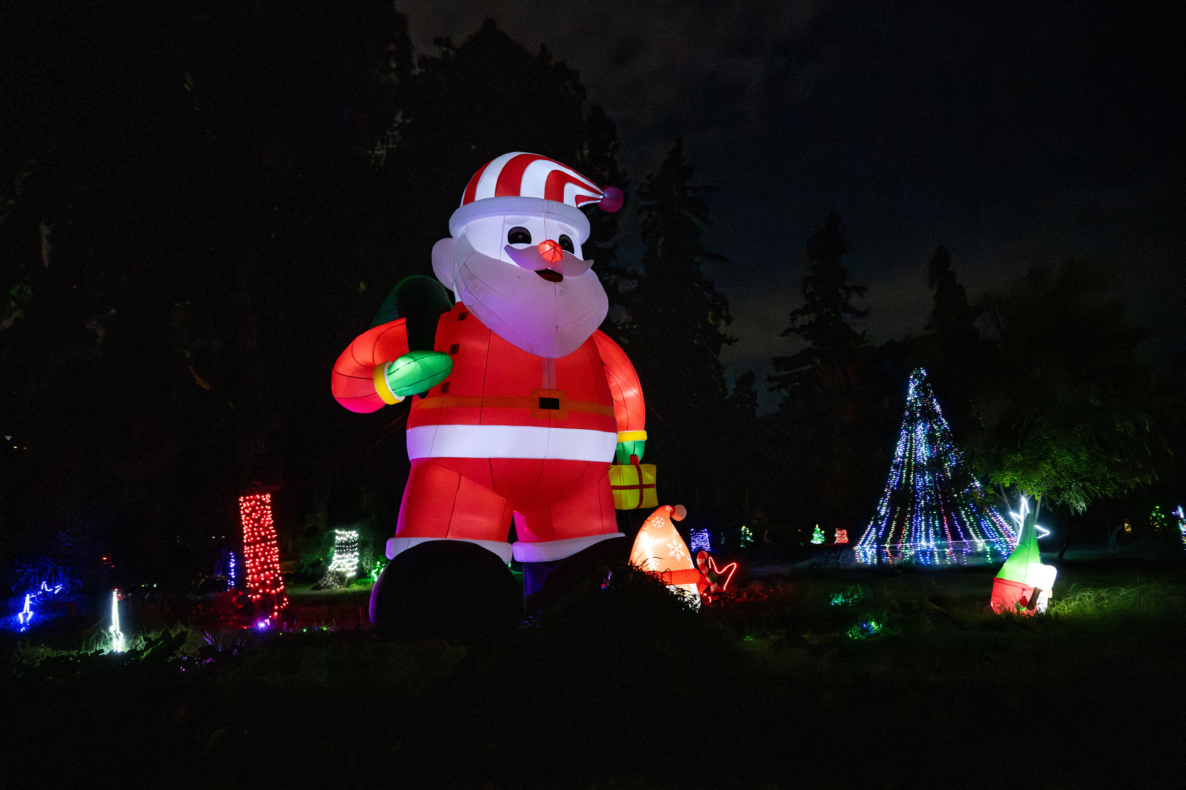A giant Santa greets passengers on the tour of holiday...