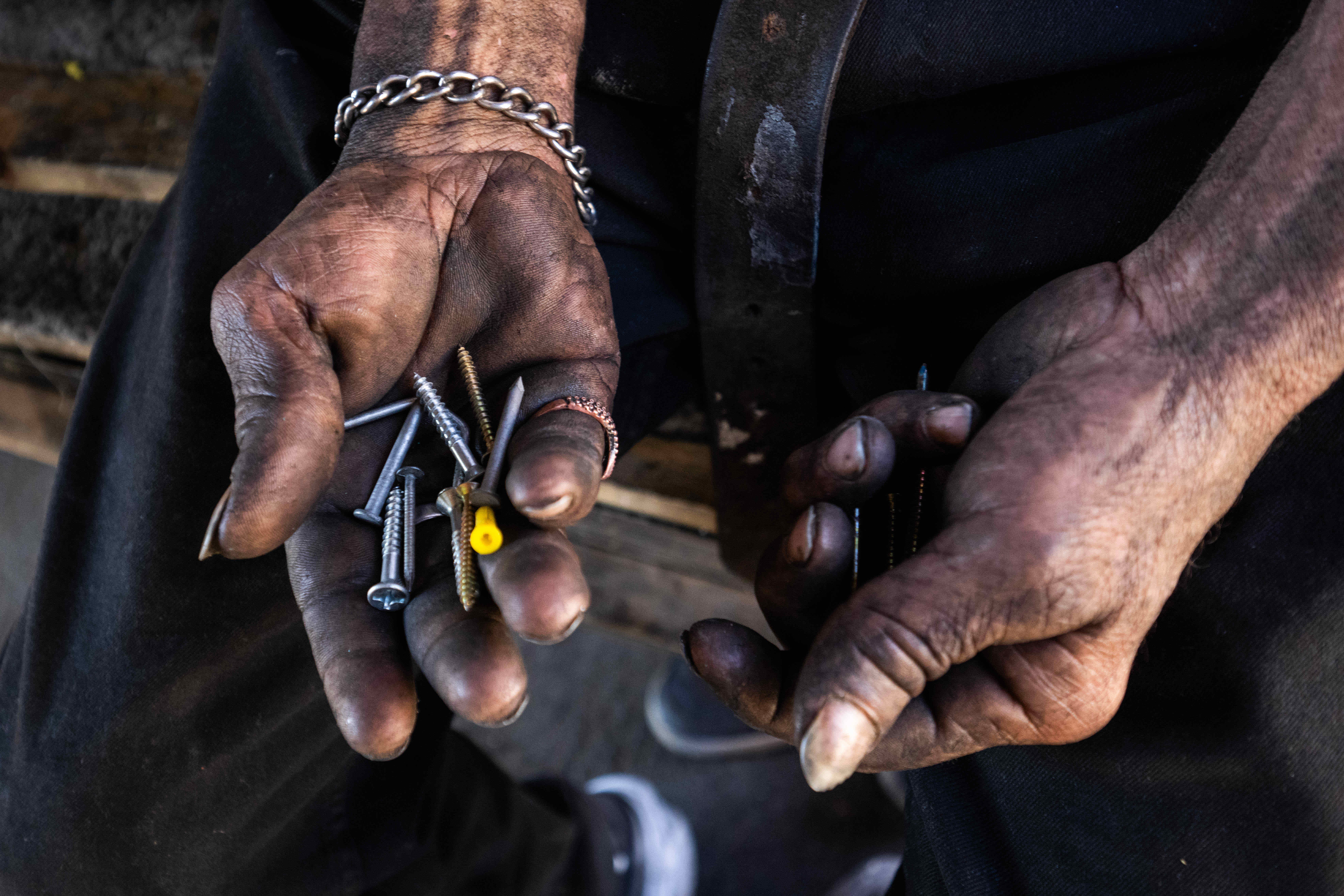 Joseph Cirincione, 47, sorts through nails as he builds a...