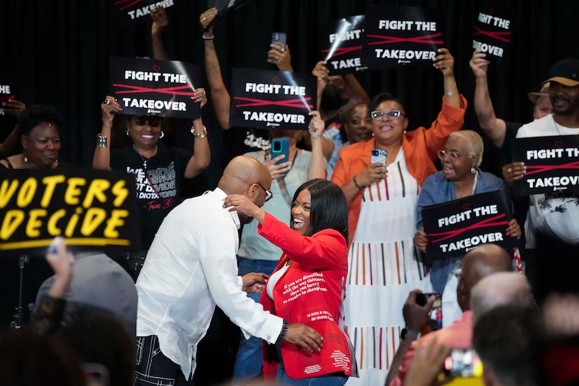 U.S. Rep. Jasmine Crockett hugs Rev. Frederick D. Haynes III, senior pastor of...