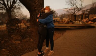 Melissa Young, center right, received a hug at her fire-ravaged home in the aftermath of the Eaton Fire, on Jan. 9, 2025, in Altadena, Calif.