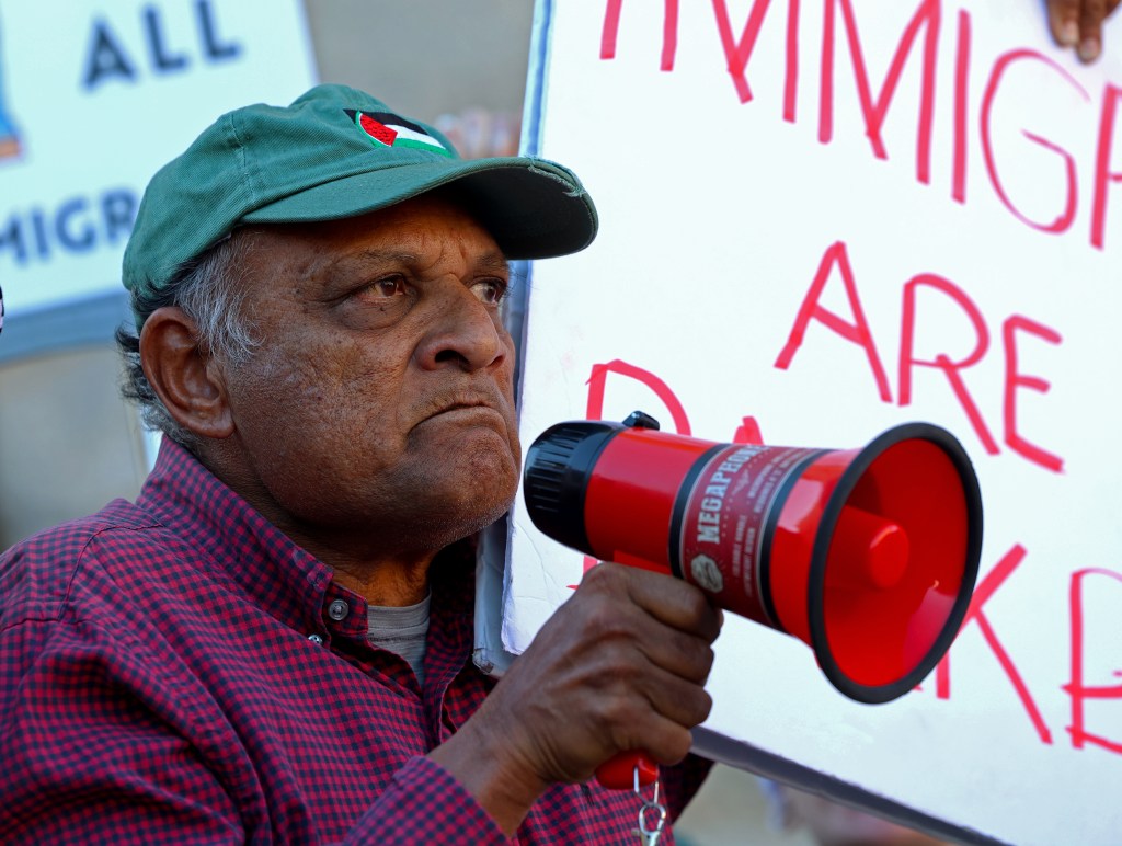 Nasir Raza, an immigrant from Pakistan, speaks to a group of protesters during the Free America Walkout at the Arizona Capitol on Jan. 20, 2026