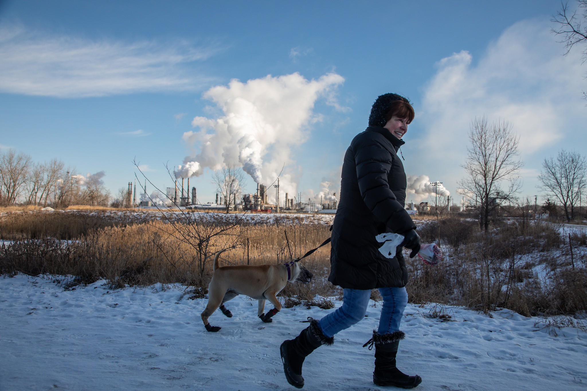 Kathy Bakutis walks with her dog Chen on the Centennial...