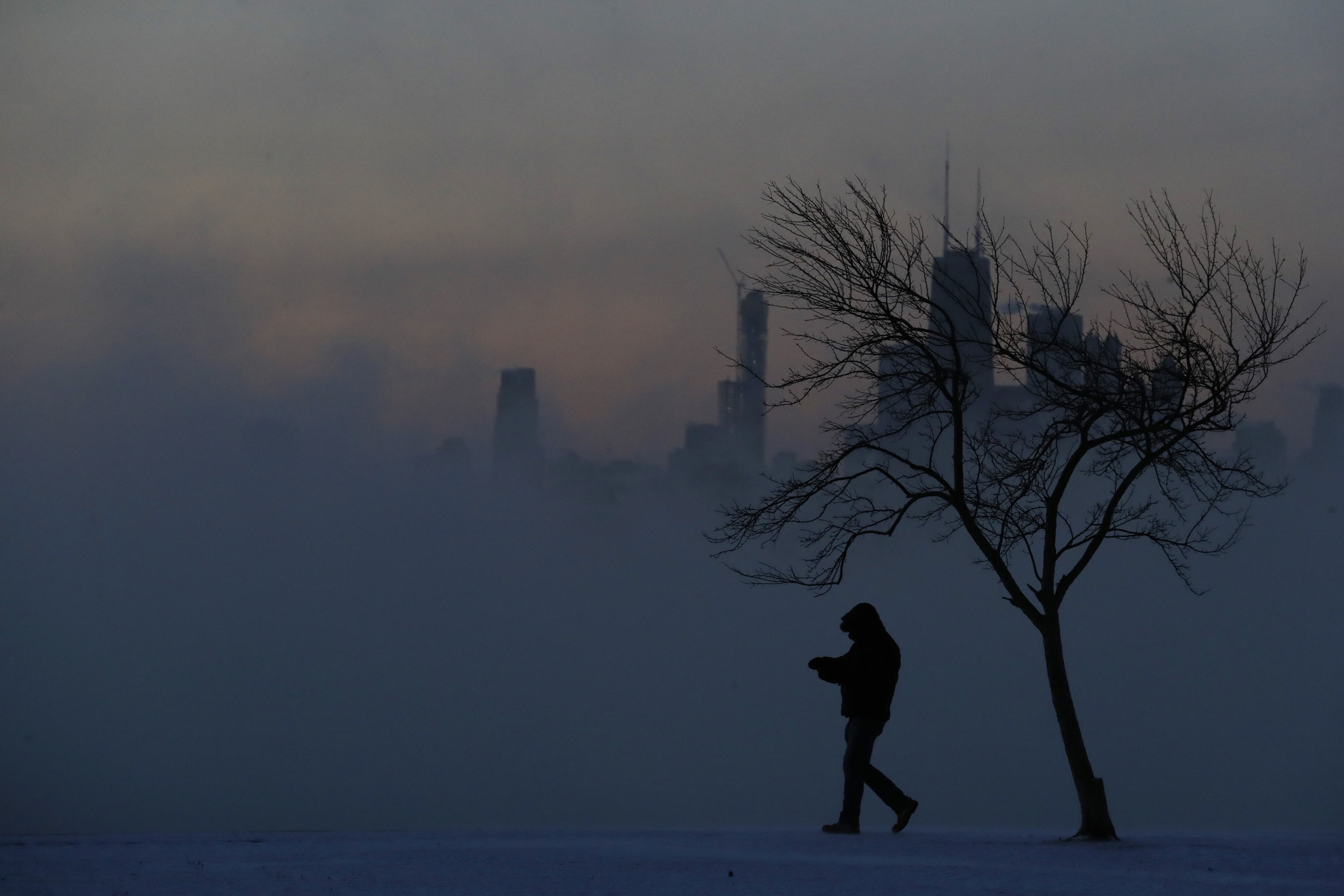The sunrise reveals a frigid Chicago lakefront near Montrose Harbor...