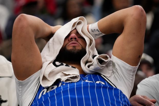 Orlando Magic guard Jalen Suggs sits on the bench after being injured during the second half of an NBA basketball game against the Chicago Bulls, Friday, Jan. 2, 2026, in Chicago. (AP Photo/David Banks)