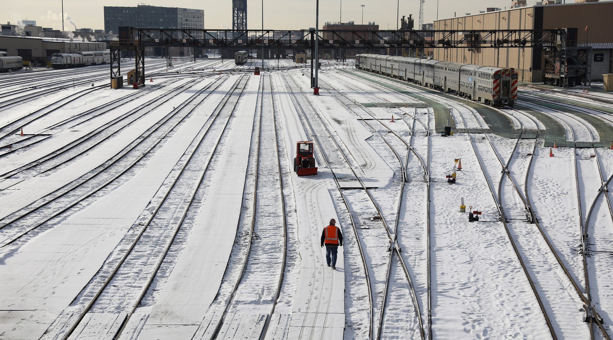 A manÂ works atÂ clearing snowÂ in the Amtrak rail yard near Roosevelt...