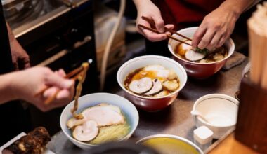 Chefs prepare bowls of ramen at Ramenya Toy Box in November in Tokyo, the capital of Japan. Pristine renditions of three classic styles won owner Takanori Yamagami induction into the ramen hall of fame in 2024.