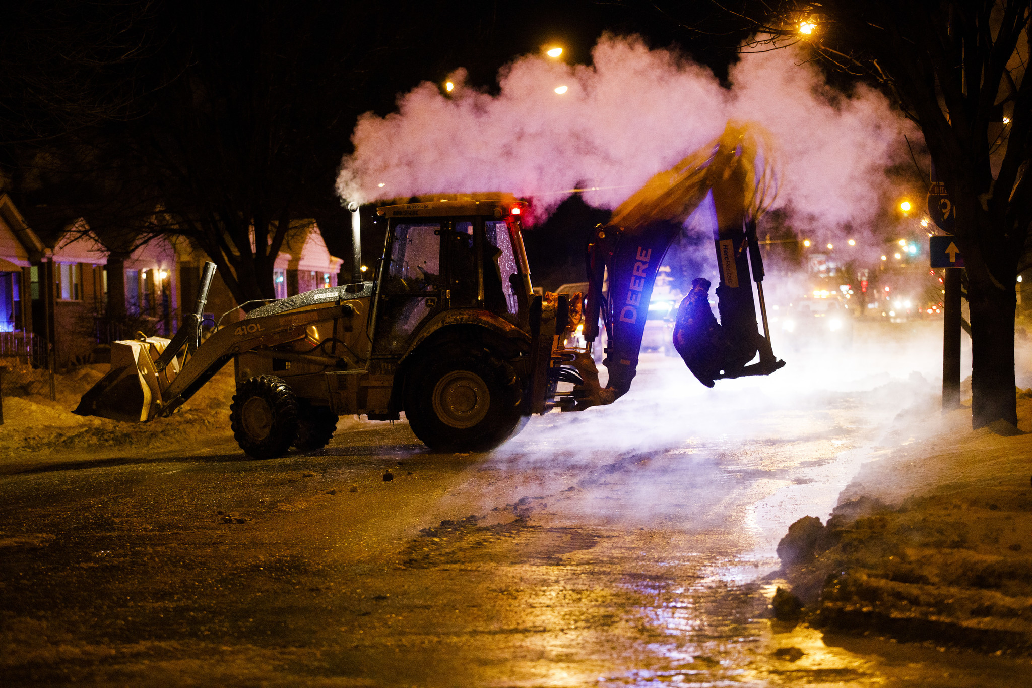 Crews work the scene of a broken water pipe that...