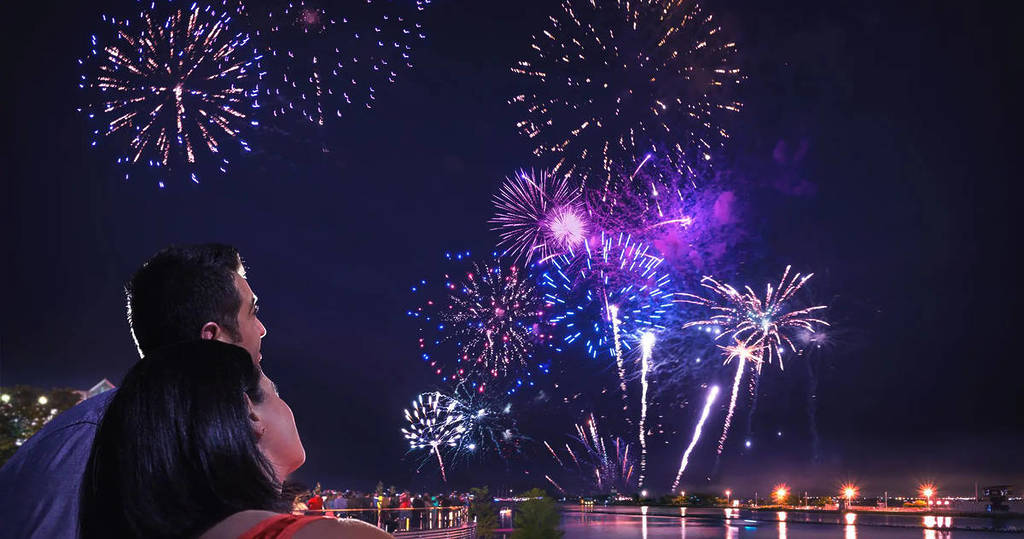 A couple watch fireworks in the sky above Navy Pier in Chicago