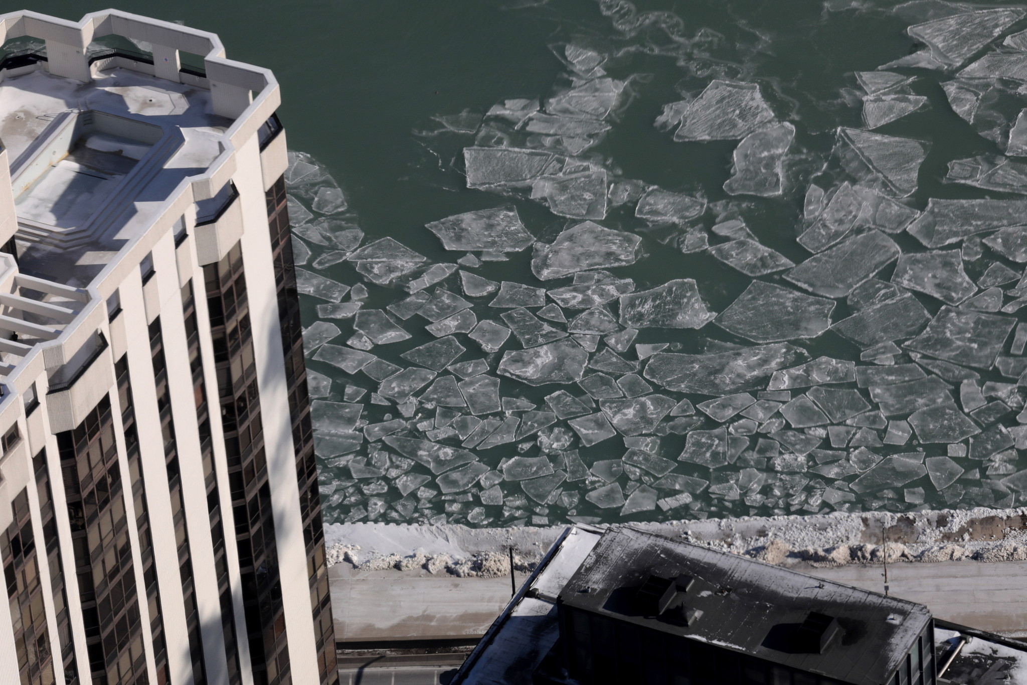 Ice begins to form on Lake Michigan as cold weather...