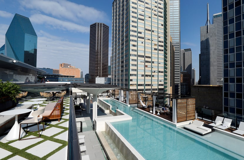 Fountain Place building (left) is seen from the the bar and pool deck areas of The National,...