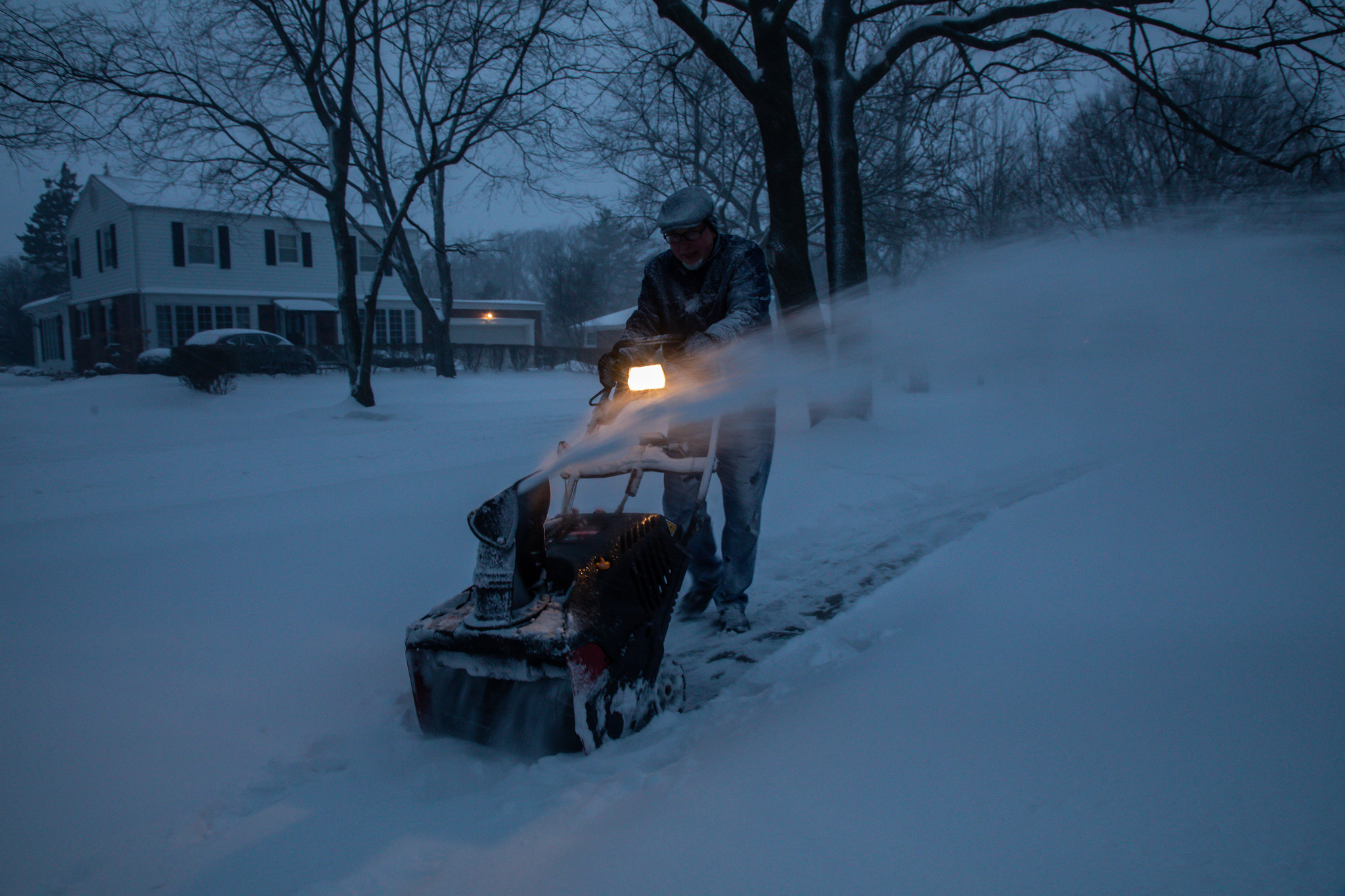 Jim Brownlee clears snow that fell overnight in Flossmoor early...