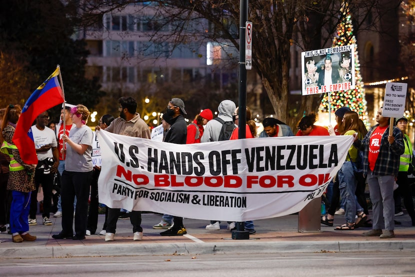 Demonstrators gather at the corner of Commerce and Harwood Streets during a 'No War with...