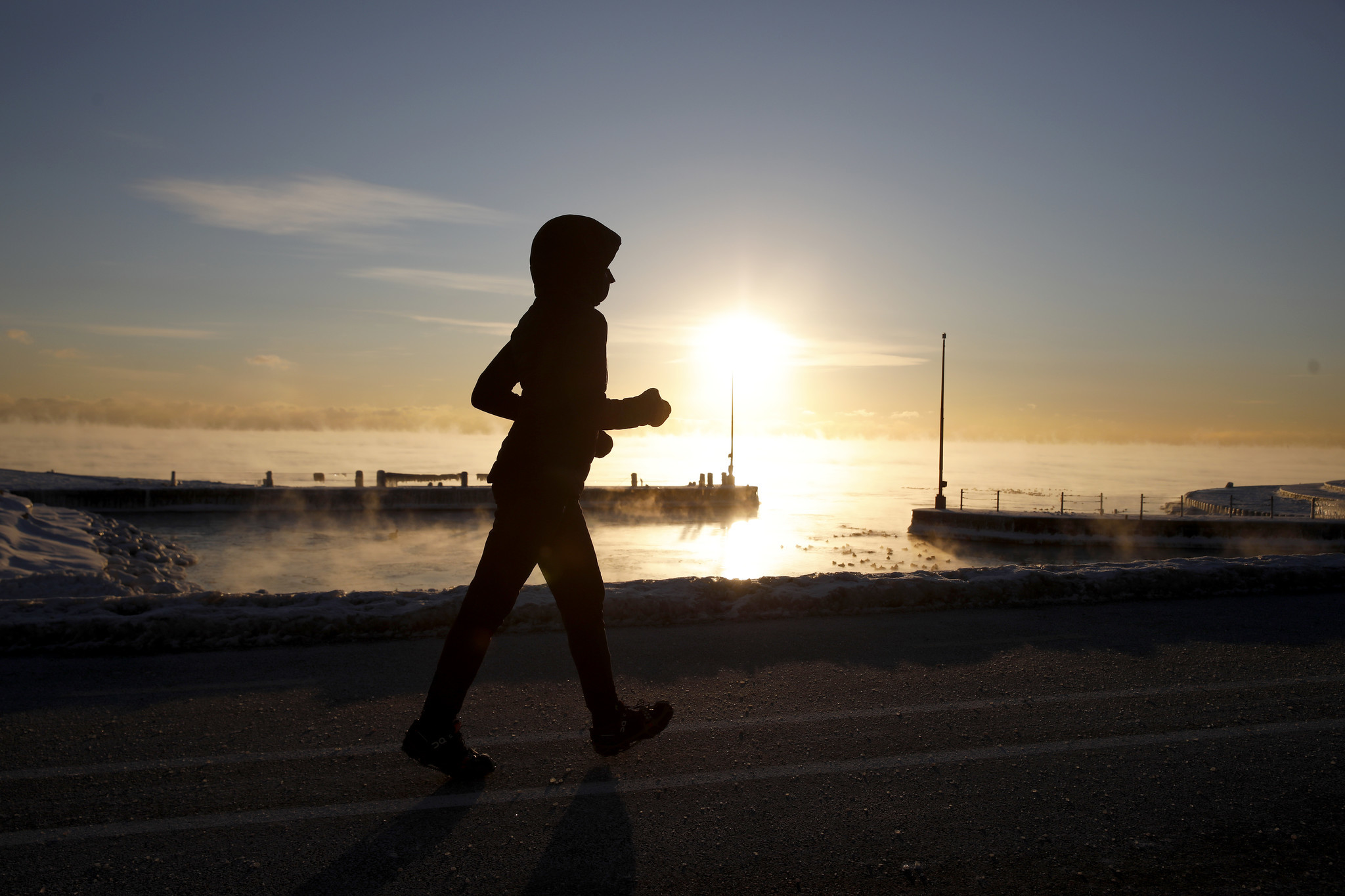 Below zero temperatures doesn't stop a woman from exercising along...