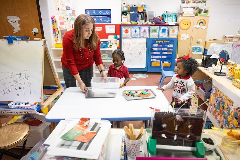 Pre-k teacher Rikki Bonet sets up a container of water and floating toys for students Toraj...