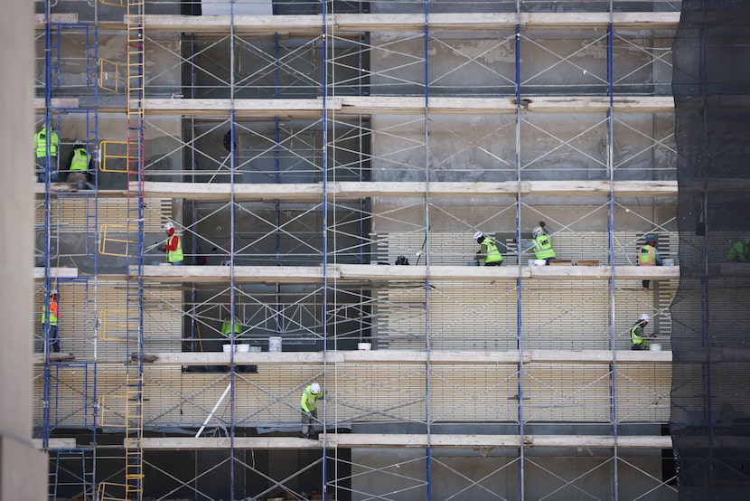 Construction continued on a midrise apartment in July 2025 in downtown Dallas. “We know that...